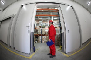 worker standing in the doorway of storehouse